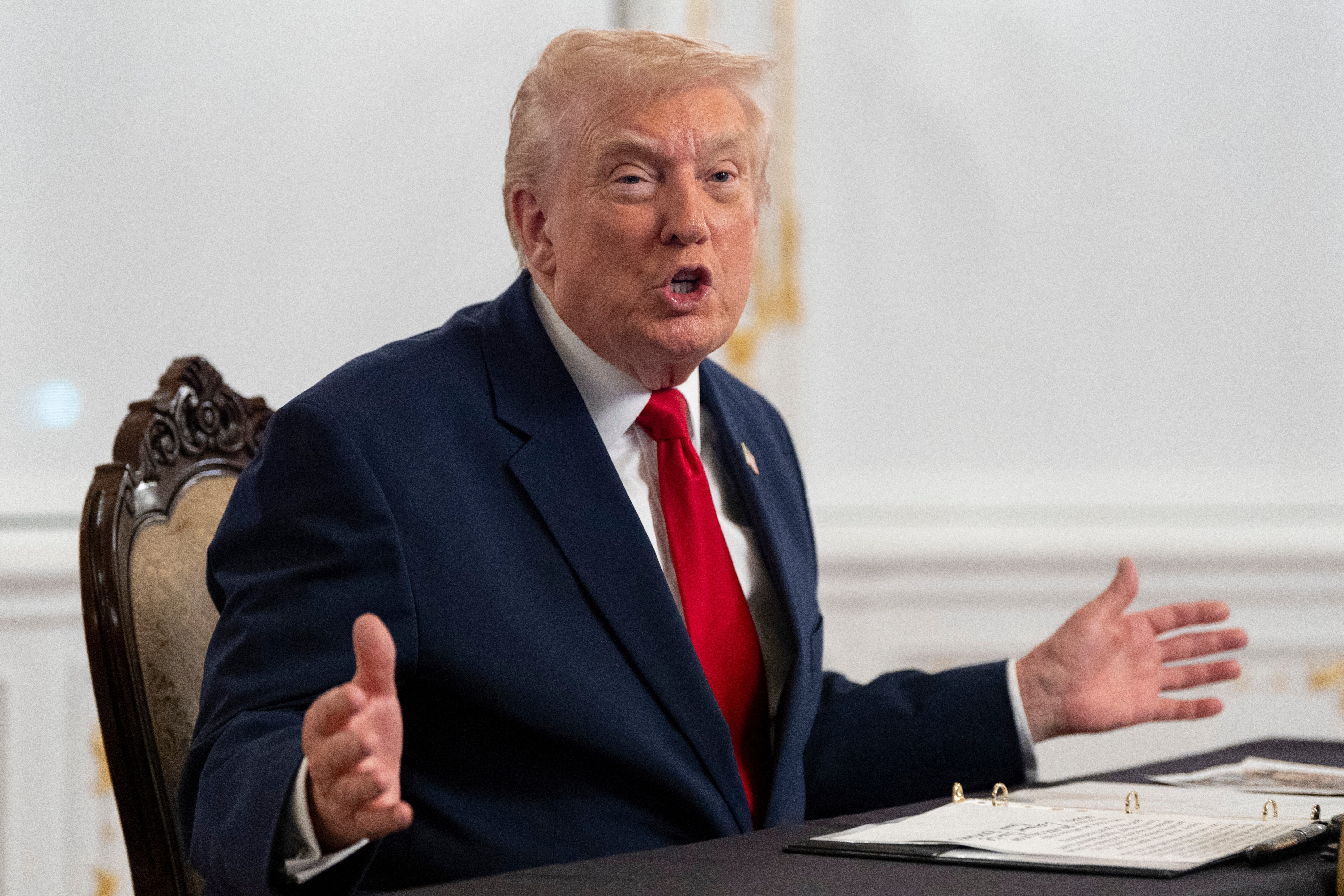President Donald Trump speaks to reporters after speaking to troops via video from his Mar-a-Lago estate on Thanksgiving, Thursday, Nov. 27, 2025, in Palm Beach, Fla.